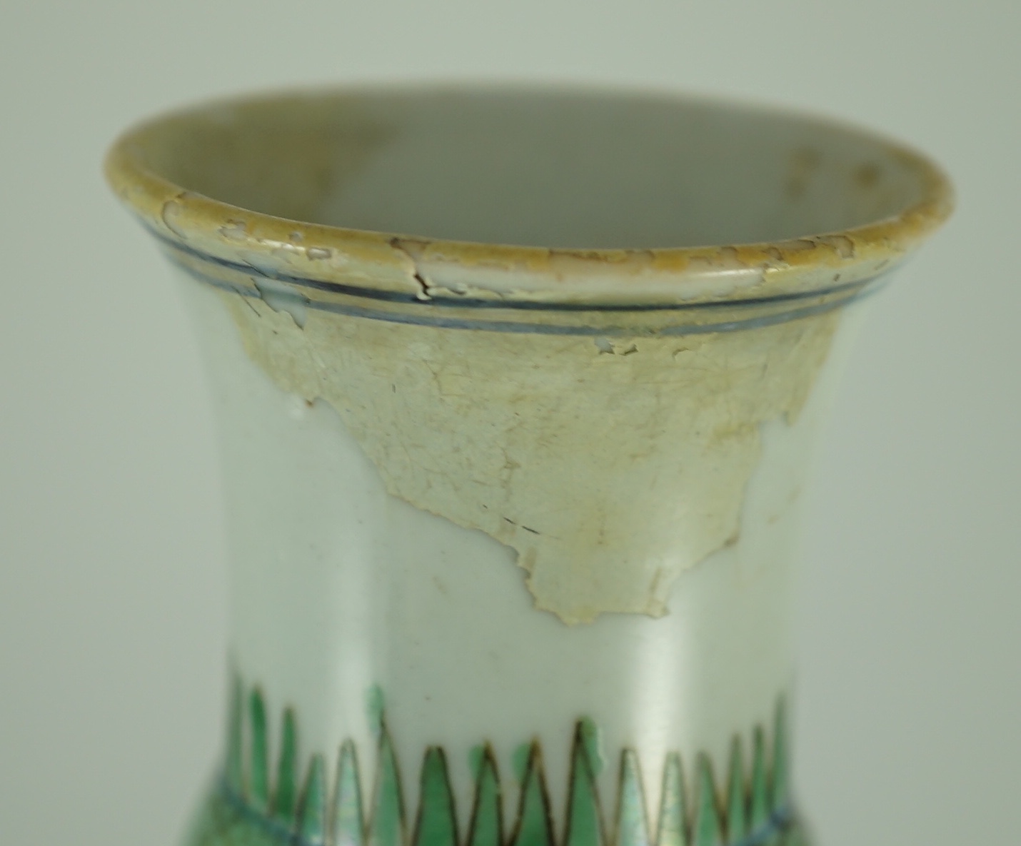 A near pair of Chinese famille verte garlic-neck vases, Kangxi period, 20cm and 20.5cm high, One vase restored